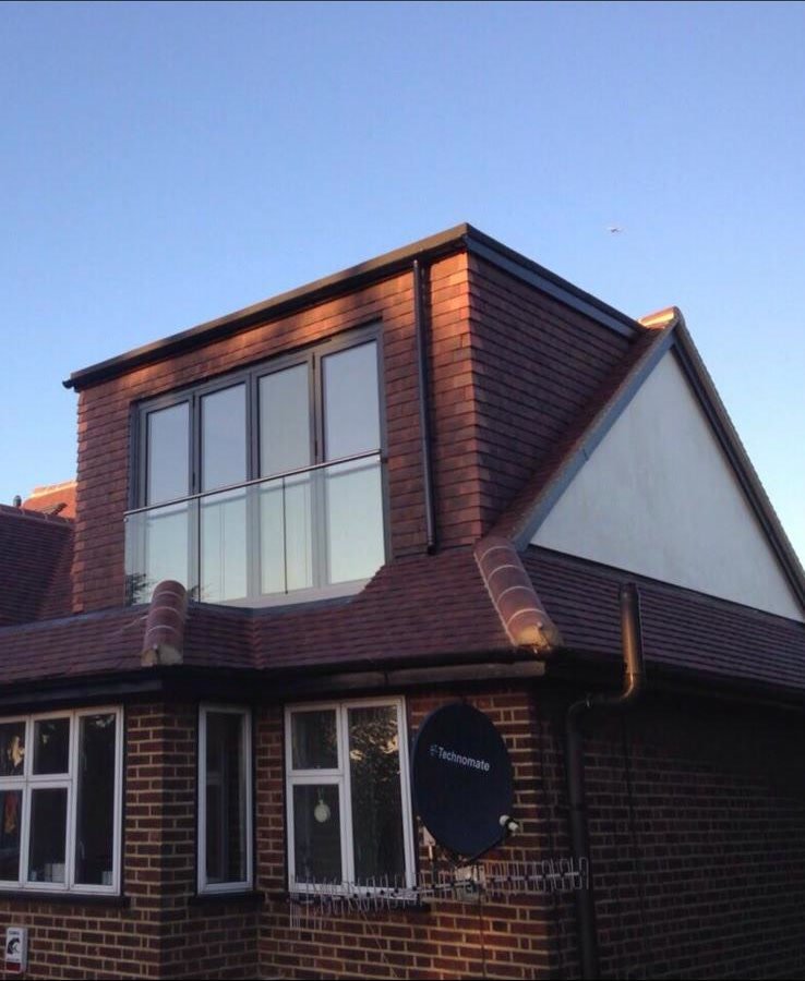 Brick dormer with large windows and a new tiled roof