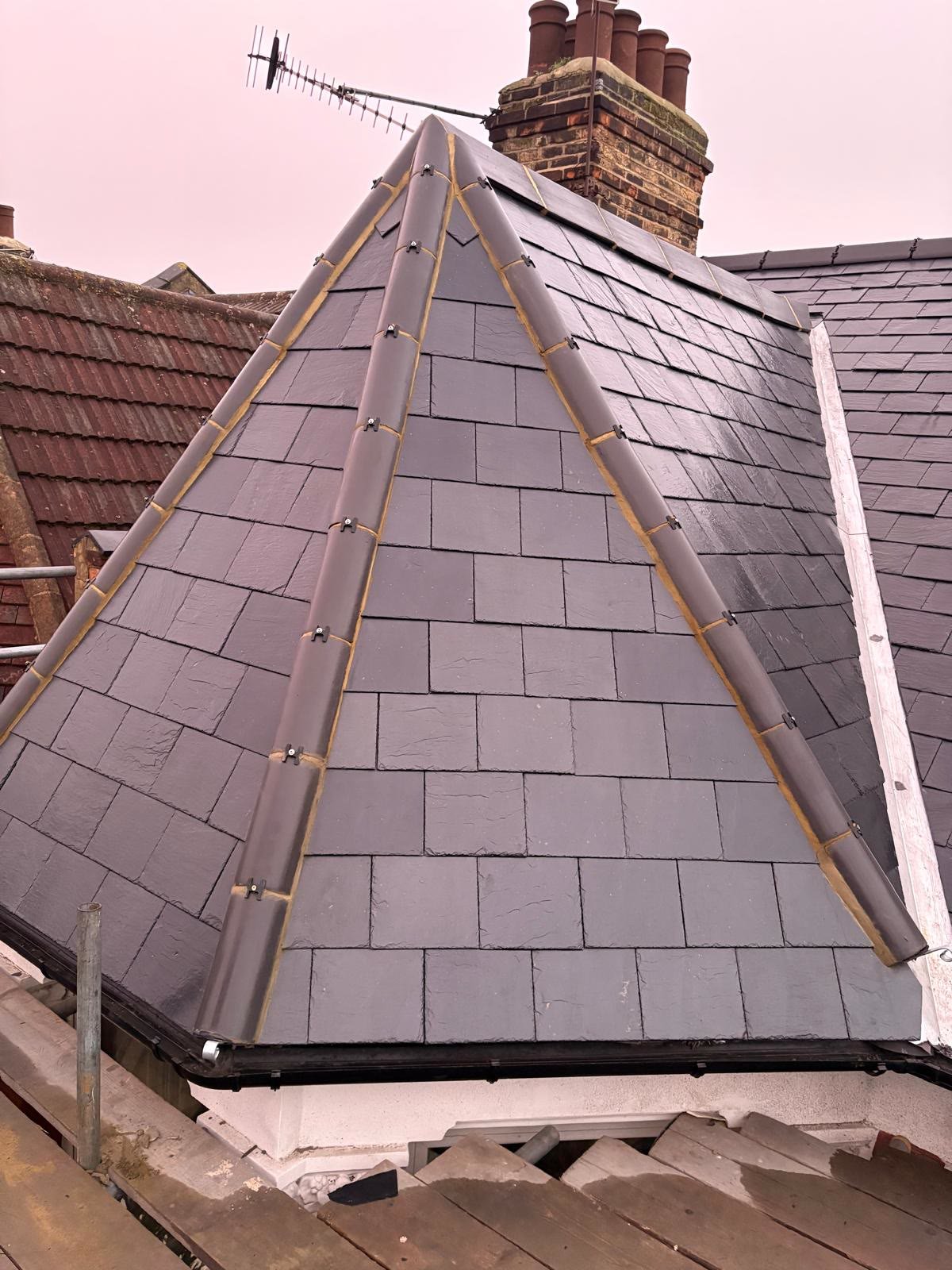 Finished slate hip roof with new ridge tiles